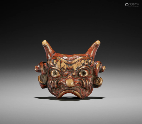 AN UNUSUAL LACQUERED WOOD MASK NETSUKE OF AN ONI