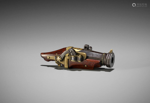 A RARE NETSUKE OF A MINIATURE TEPPO (RIFLE)