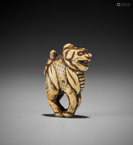 A RARE AND EARLY STAG ANTLER NETSUKE OF A KIRIN