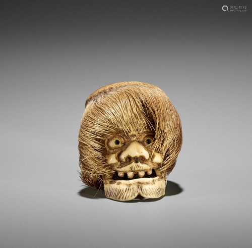 A STAG ANTLER NETSUKE OF A FOREIGNER'S HEAD