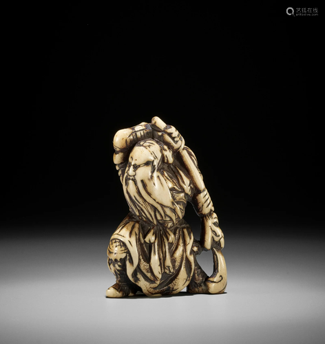 A POWERFUL STAG ANTLER NETSUKE OF KAN'U