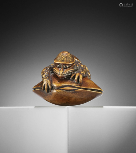 A RARE WOOD NETSUKE OF A KAPPA ON HAMAGURI CLAM