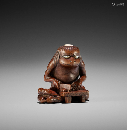 AN INLAID WOOD NETSUKE OF A KAPPA WITH CUCUMBERS