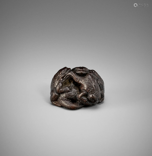 A TSU SCHOOL DARK WOOD NETSUKE OF FIVE TOADS