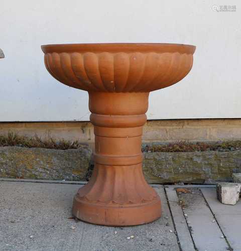 A terracotta coloured stoneware garden planter,