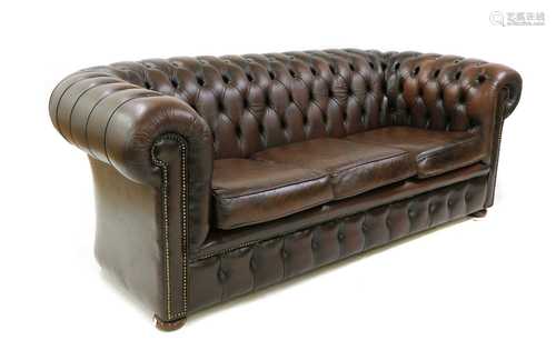 A brown leather three seater Chesterfield sofa,