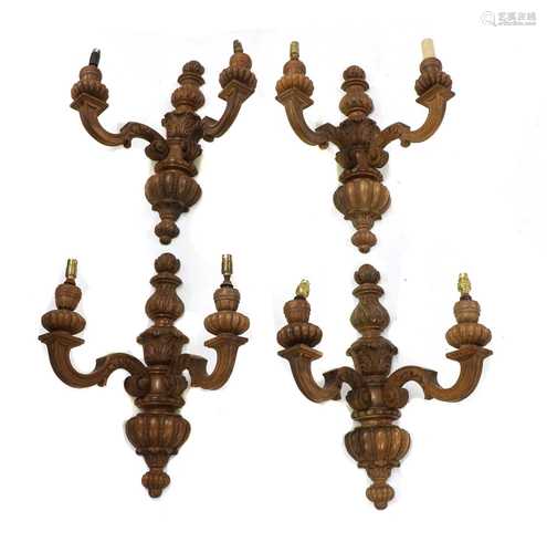 A set of four carved walnut twin branch wall lights,