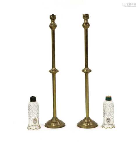 A pair of brass floor standing storm lanterns,