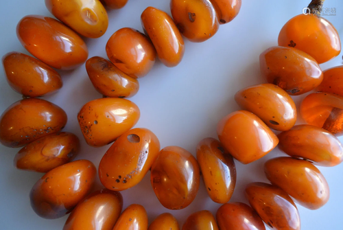 A STAND OF BEEWAX BRACELET NECKLACE