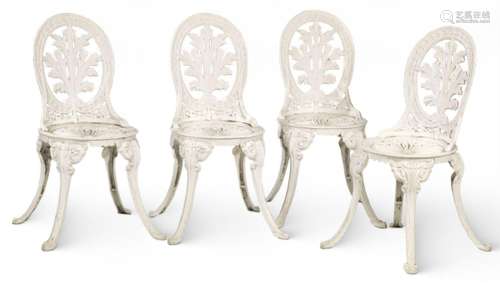Set of four chairs and a garden table in cast iron and paint...