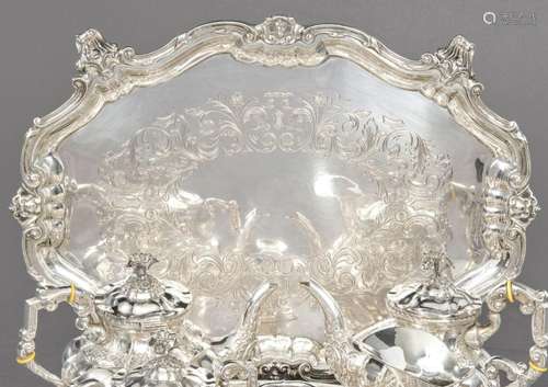 Oval tray with four legs in punched Spanish silver. With eng...