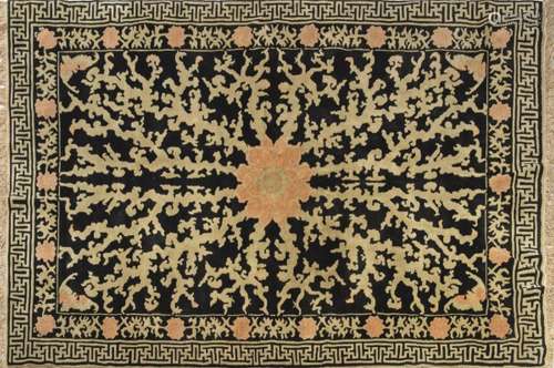 Chinese wool rug. With black field and decoration in beige a...