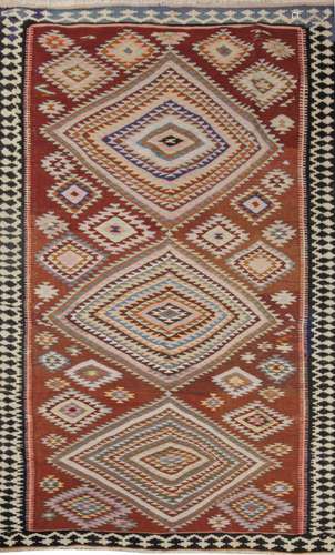 Turkmen kilim woven in wool. With red field and rhombus deco...