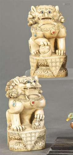 Pair of Foo lions carved in ivory inlaid with coral, turquoi...