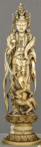 Guanyin with Dragon" carved in ivory with touches of bl...