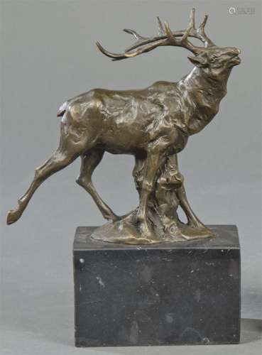 Deer in patinated bronze 20th century. On black marble base....