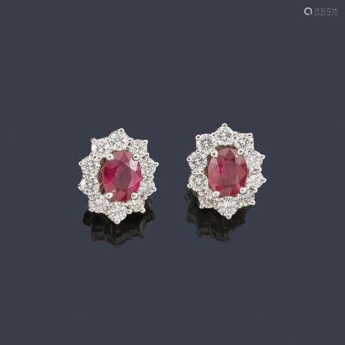 Short earrings with a pair of oval cut rubies of a…