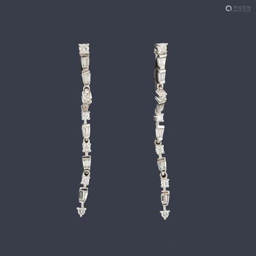 Long earrings with a baguette cut diamond band int…