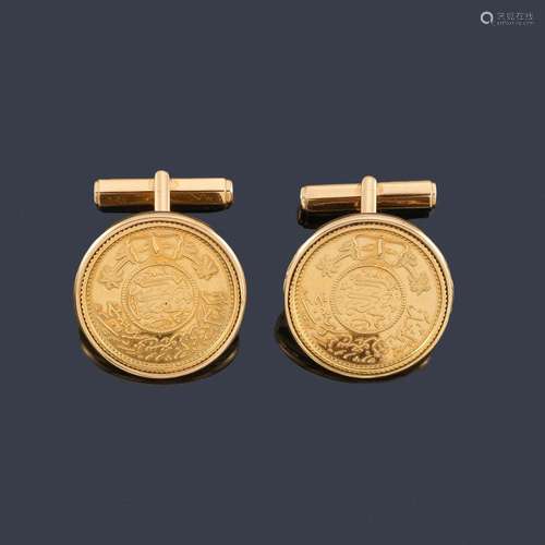 18K yellow gold cufflinks set with a coin motif. …