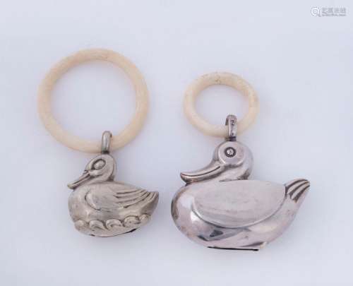Two baby rattles, one sterling silver the other German silve...