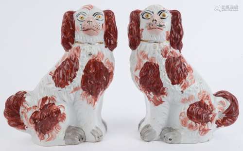 A pair of Staffordshire pottery spaniels, 19th century, 24cm...