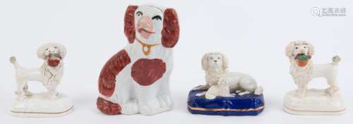 Four assorted Staffordshire pottery dog statues,19th century...