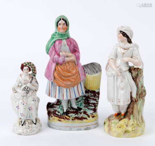 Three Staffordshire pottery statues of women, 19th century, ...