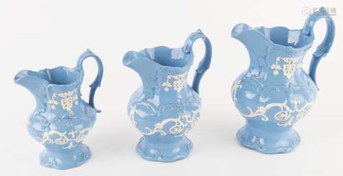 A graduated set of three slip ware English porcelain jugs, 1...