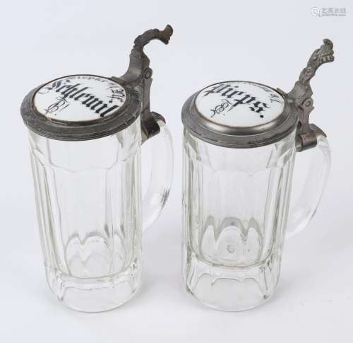 A pair of German antique beer steins, pressed glass with pew...