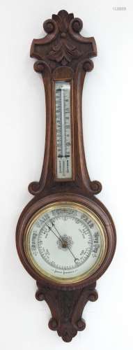 An antique English aneroid banjo barometer in oak case, 19th...