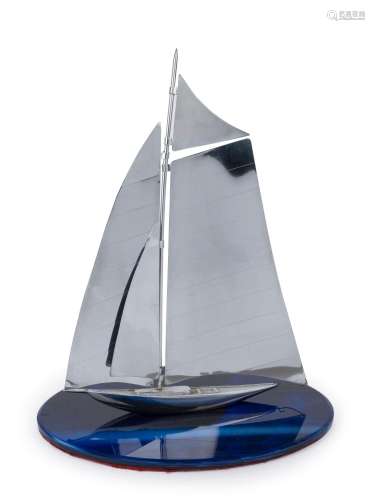 An Art Deco chrome yacht ornament on blue glass base, circa ...