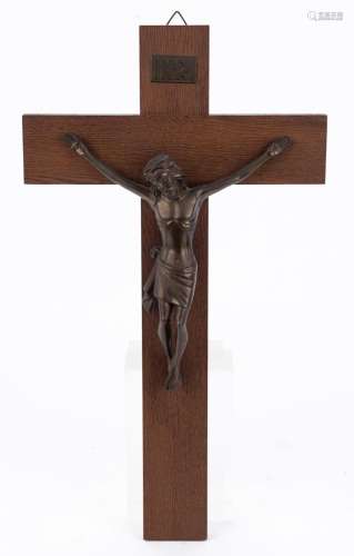 A wall mounted crucifix, cast bronze and oak, mid 20th centu...
