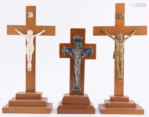 Three assorted free standing crucifix statues, 20th century,...