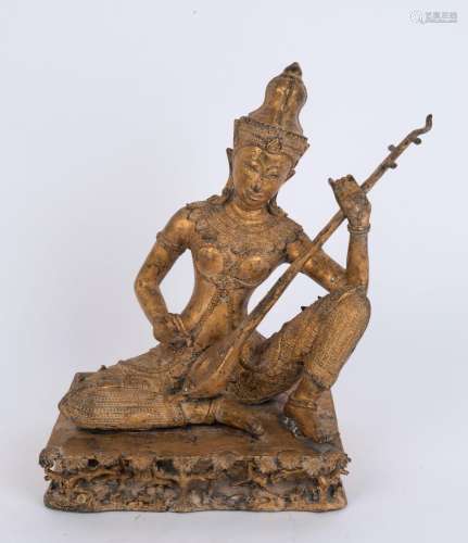 A Thai seated gilt bronze statue of a musician, 19th/20th ce...