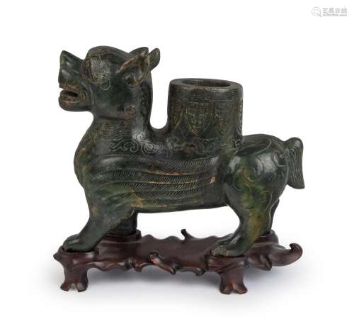 A Chinese carved green jade winged dragon with scroll work a...