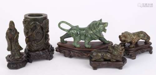 Group of five Chinese carved green jade ornaments, 20th cent...