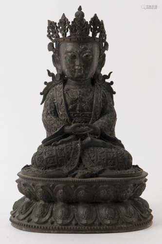 A Tibetan bronze statue of Amitayus wearing a crown and neck...