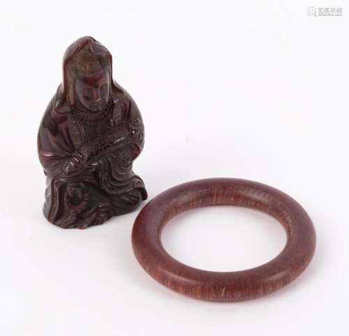 A Chinese carved horn bangle and seated Guanyin statue, Qing...