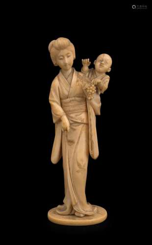 A Japanese carved ivory statue of a lady and child with grap...