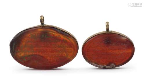 Two antique Islamic calligraphic amulets, carved agate in go...