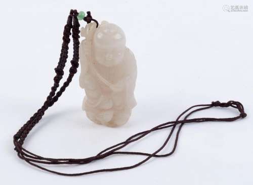 A Chinese mutton jade amulet of a boy holding a Ruyi adorned...