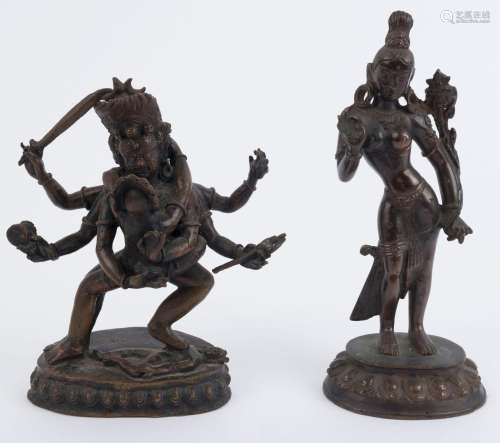 A Tibetan bronze statue of a six armed demonic figure with h...