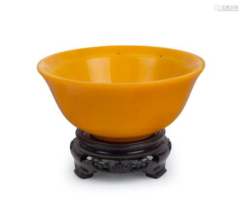 PEIKING GLASS bowl in Imperial yellow on carved wooden stand...