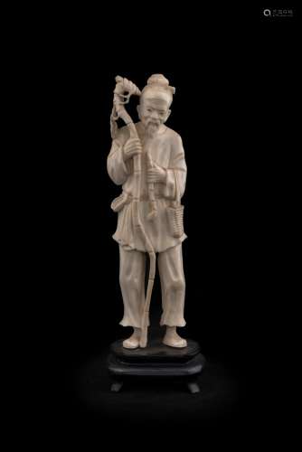 A Chinese carved ivory statue of an elderly man, early to mi...