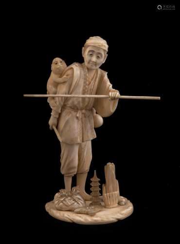A Japanese carved ivory statue man with monkey, Meiji period...