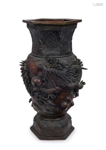 An antique Japanese bronze dragon vase with hexagonal form t...