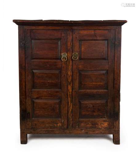 An antique English pine and oak two door cabinet with fielde...