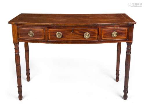 A Georgian bow front three drawer mahogany desk, cross bande...