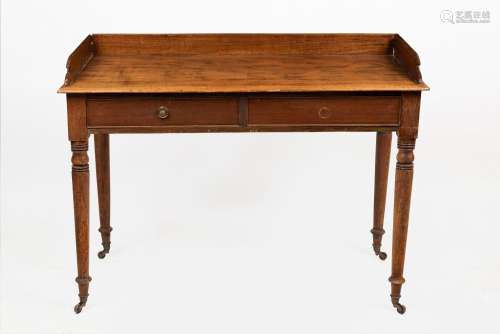 An antique English mahogany two drawer desk with gallery, ea...