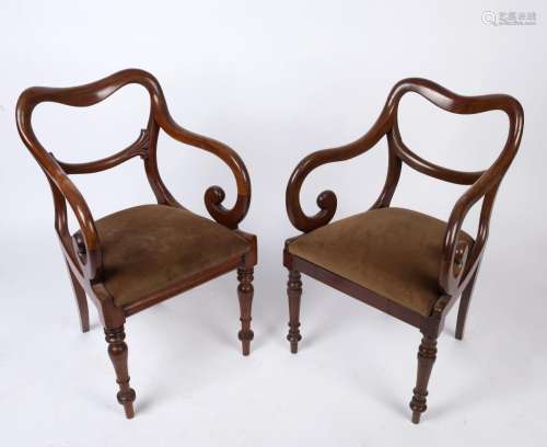 A pair of English mahogany saddleback carver chairs with dro...